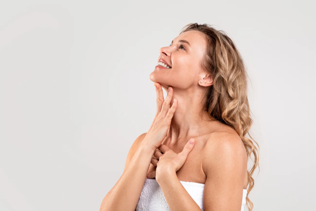 Beautiful Middle Aged Woman Touching Smooth Skin On Neck photo for neck lift