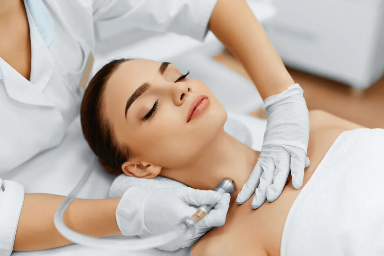 Face Skin Care. Closeup Of Beautiful Woman Getting Diamond Microdermabrasion Peeling Treatment In A Beauty Spa Salon