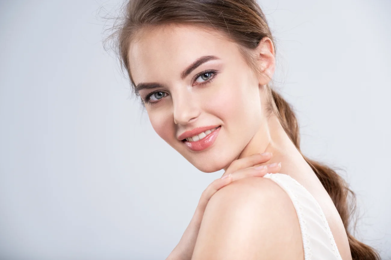 Portrait of a smiling young woman with a brown hair