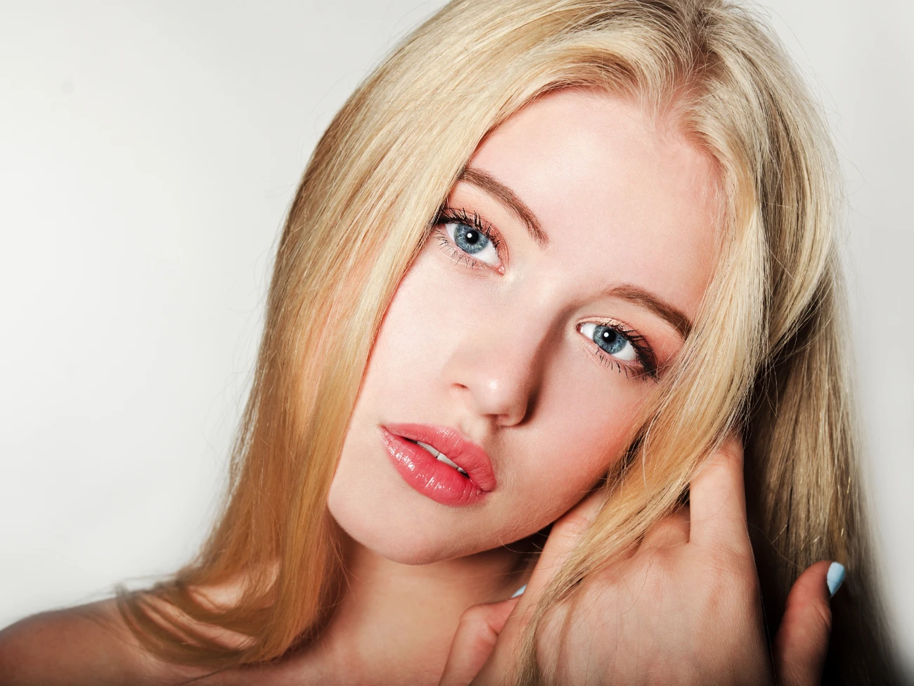 Portrait of beautiful blonde young woman face. Spa model girl with fresh clean skin.
