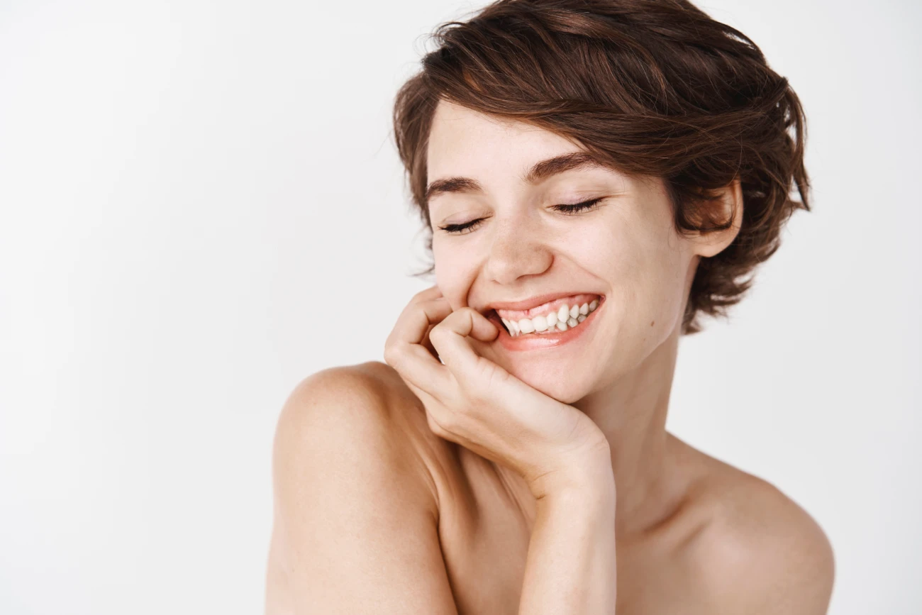 Skincare and women beauty. Girl with natural look smiling, standing on white background naked body. chemical peel treatment