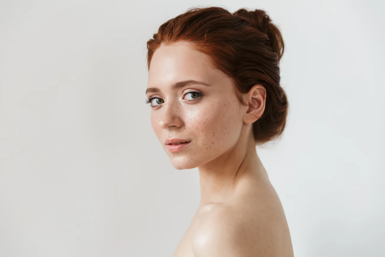 Young redhead woman posing isolated over white wall background photo for facelift