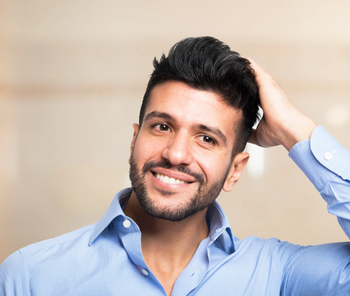 smiling male running hand through hair