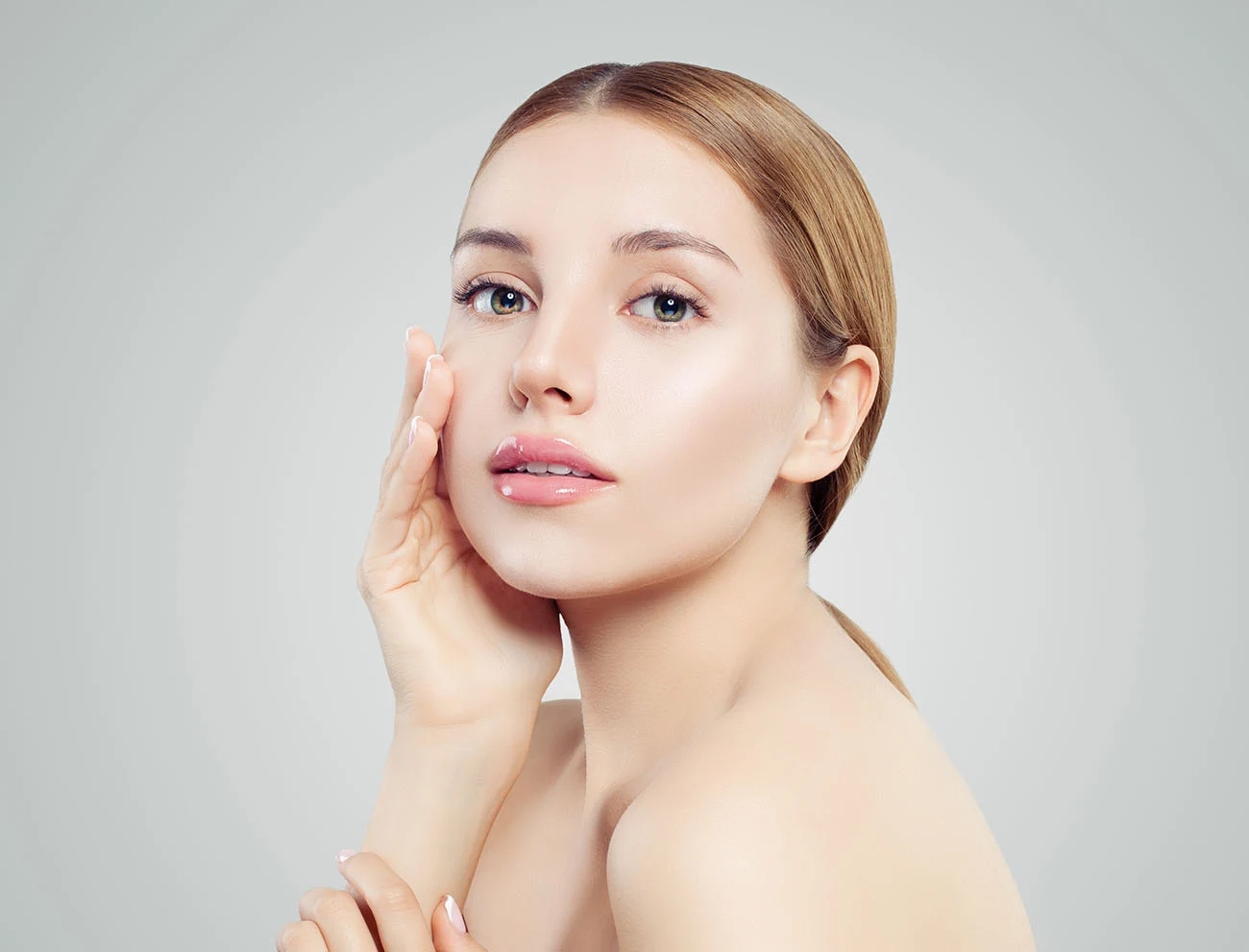 Beautiful woman touching her face gently.