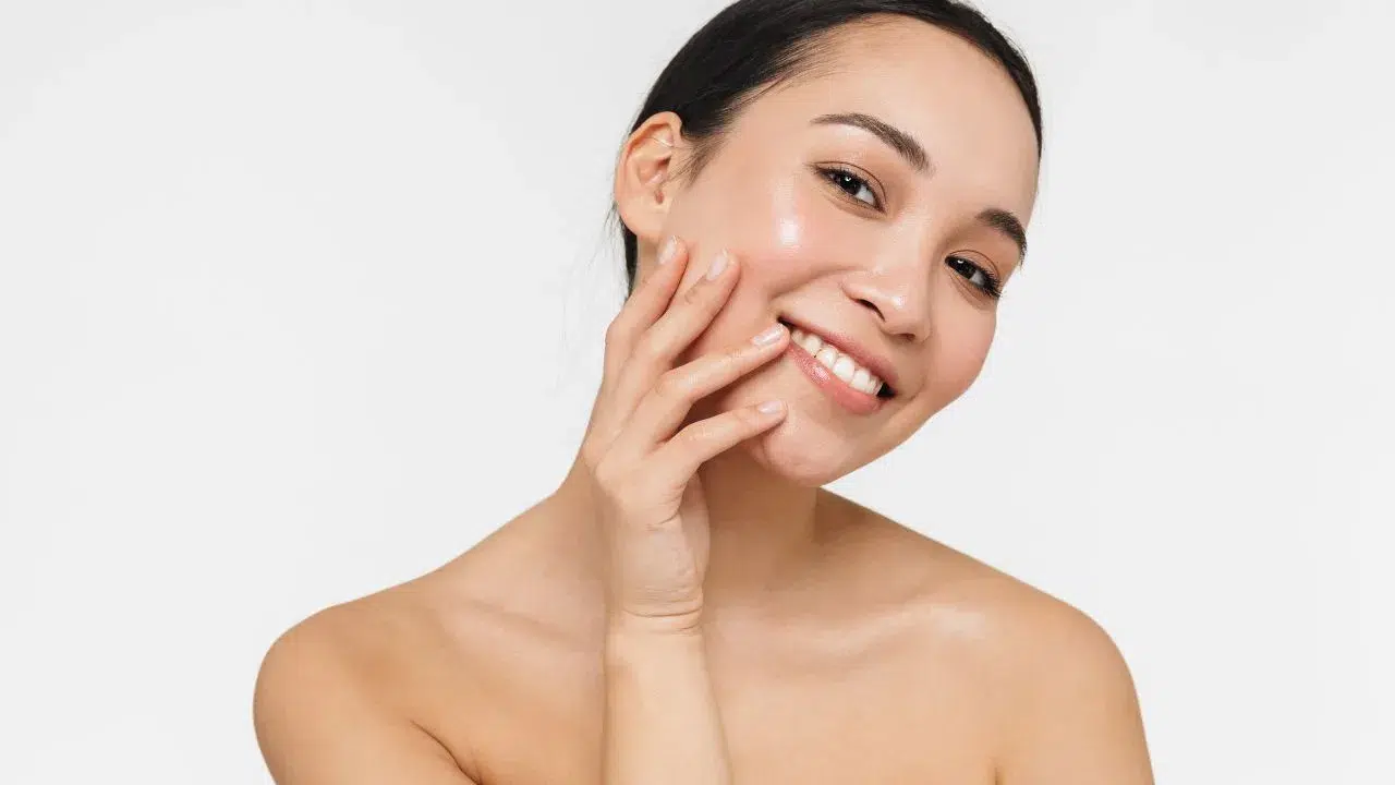Skincare. Woman with beautiful face touching healthy facial skin. Skincare. Woman with beautiful face touching healthy facial skin.