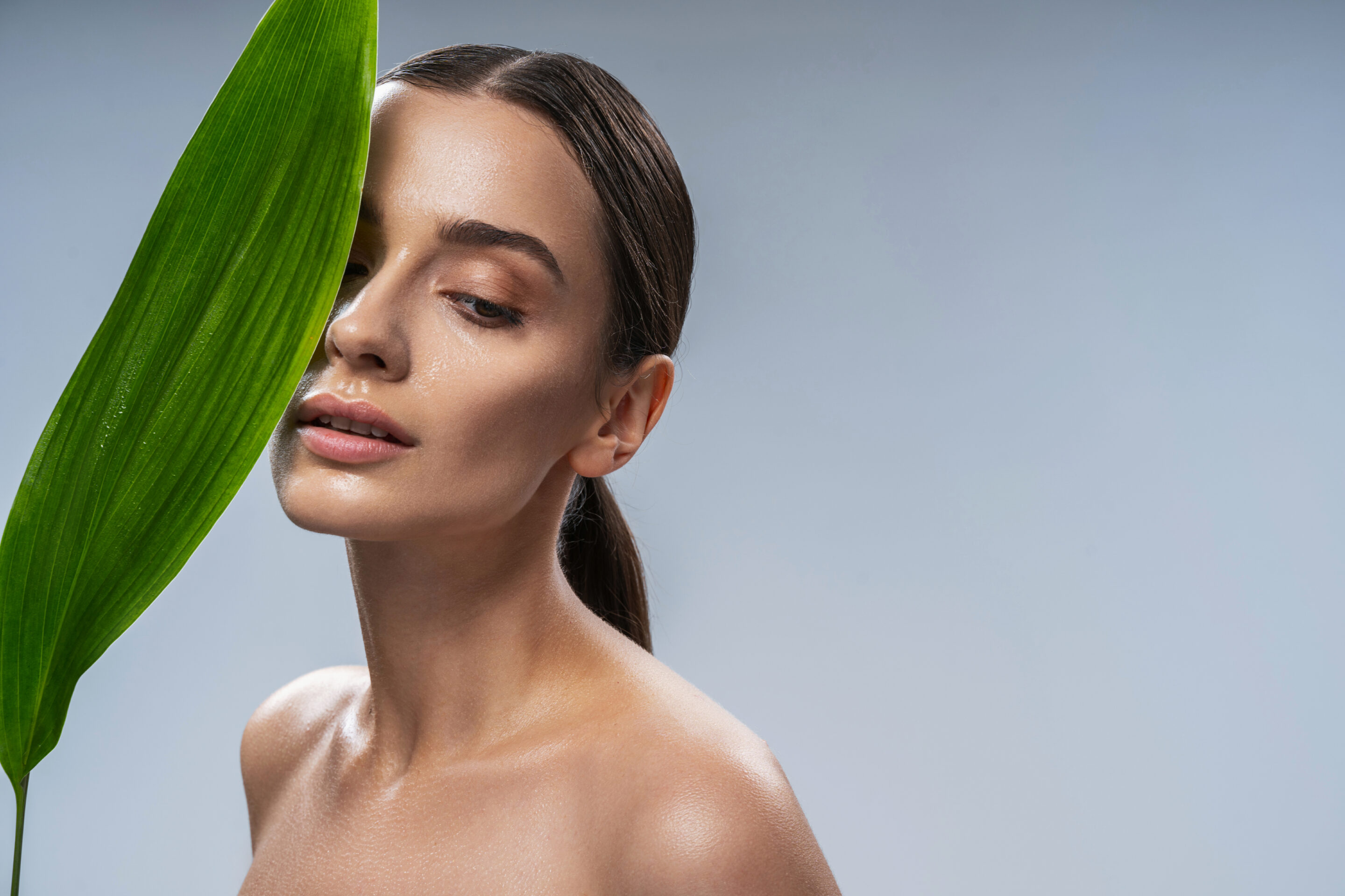 Skincare. Woman with beautiful face touching healthy facial skin.